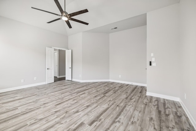 empty room with ceiling fan and light hardwood / wood-style floors