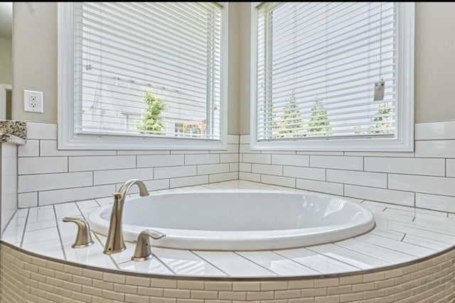 bathroom featuring a relaxing tiled tub