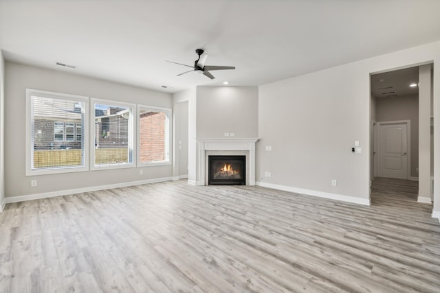 unfurnished living room featuring light hardwood / wood-style flooring and ceiling fan