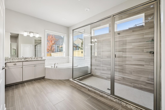 bathroom with vanity and separate shower and tub