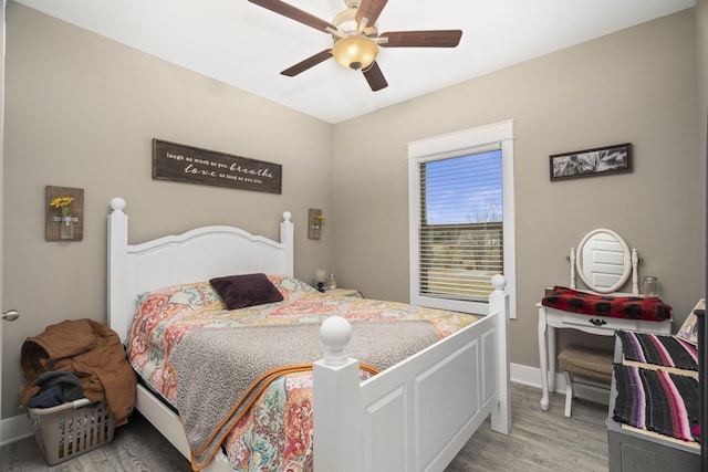 bedroom with ceiling fan and light hardwood / wood-style floors