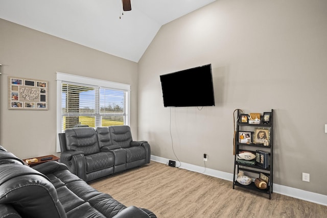 living room with vaulted ceiling, ceiling fan, and light hardwood / wood-style floors