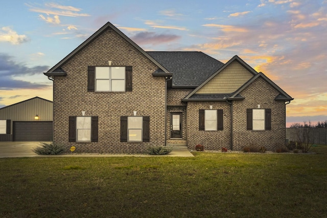 view of front facade featuring a garage and a lawn