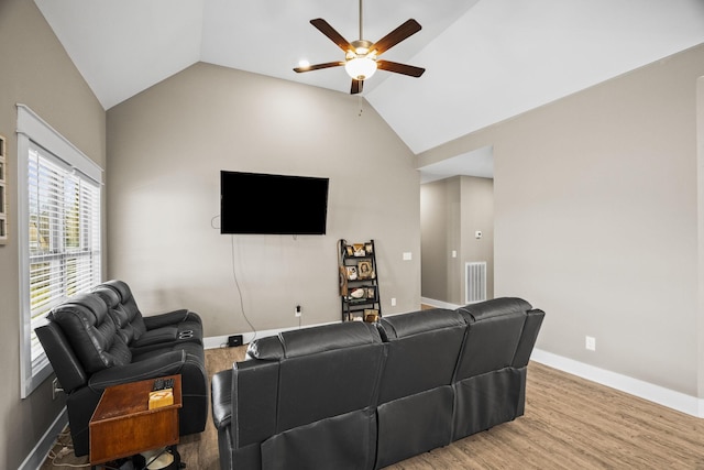 living room with vaulted ceiling, ceiling fan, and hardwood / wood-style floors