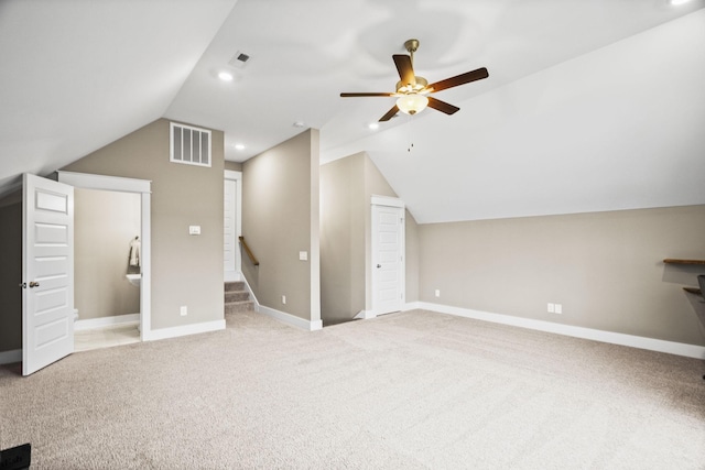 additional living space with ceiling fan, lofted ceiling, and light carpet