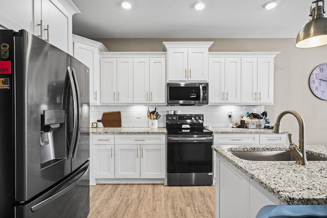 kitchen featuring sink, stainless steel appliances, and white cabinets