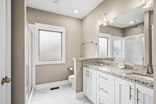 bathroom with vanity, an enclosed shower, and toilet