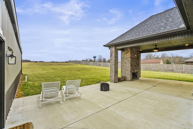 view of patio featuring ceiling fan and a fireplace