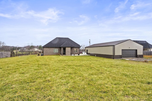 view of yard with a garage and an outdoor structure