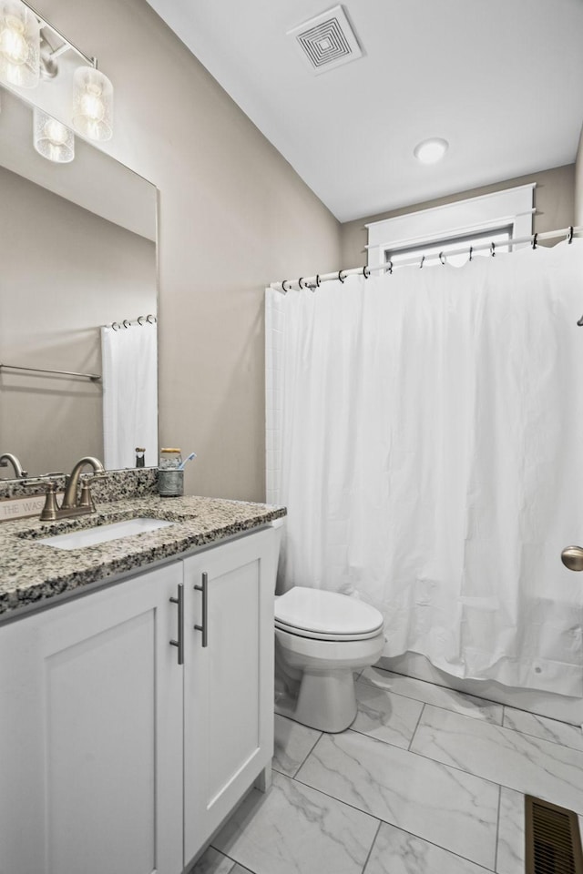 full bathroom featuring shower / tub combo with curtain, vanity, and toilet