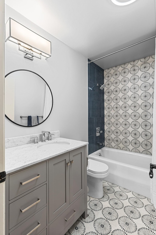 full bathroom featuring vanity, tile patterned floors, toilet, and tiled shower / bath