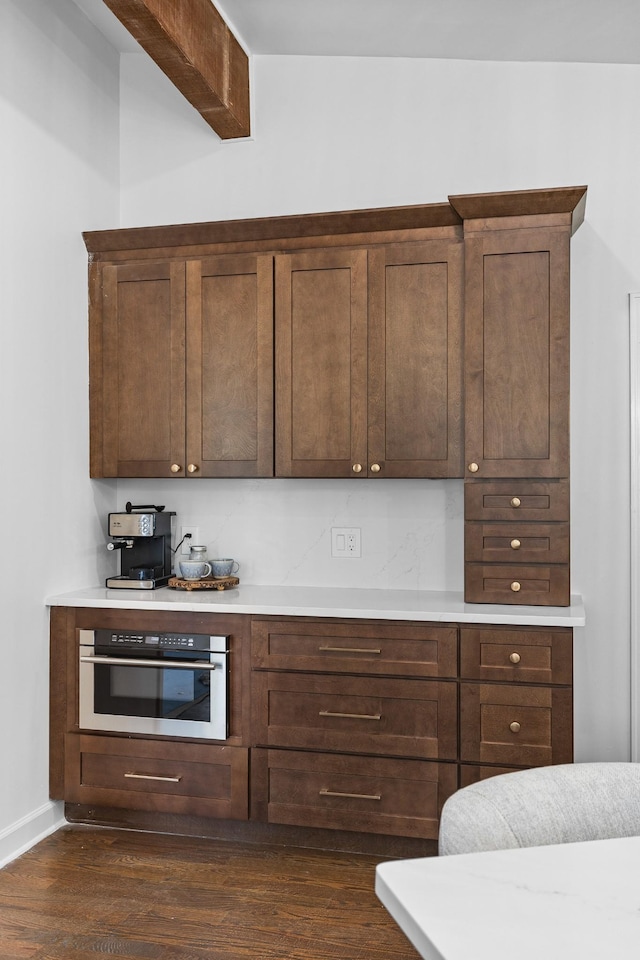 kitchen with dark hardwood / wood-style flooring and oven