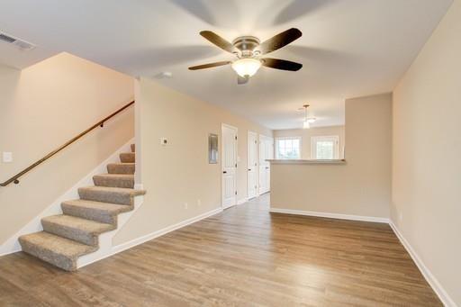 empty room with hardwood / wood-style floors and ceiling fan