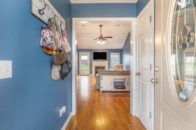 hallway with baseboards and wood finished floors