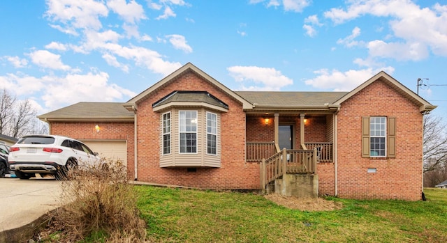 ranch-style home featuring a porch, a garage, brick siding, concrete driveway, and a front lawn