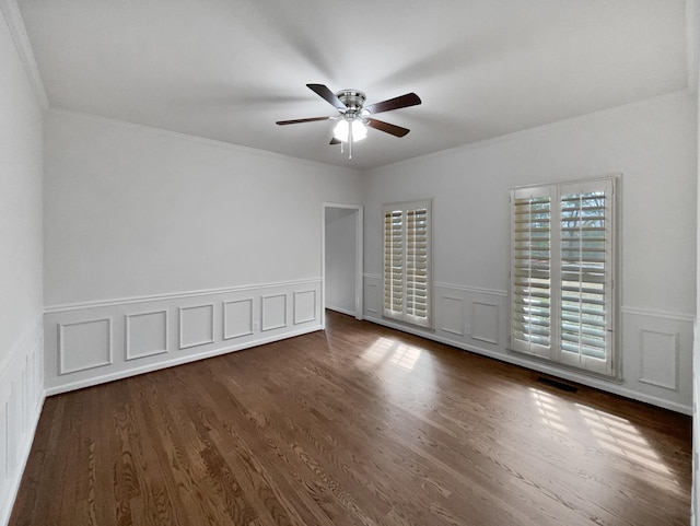 3556 Forest Park Rd, Springfield, TN 37172 - unfurnished room featuring ceiling fan, dark wood-type flooring, ornamental molding, a wainscoted wall, and a decorative wall