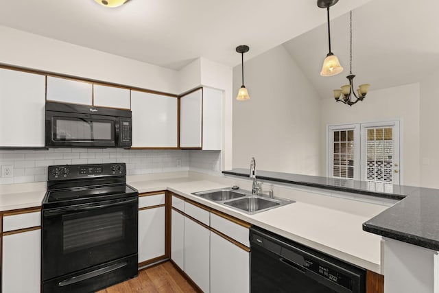 kitchen featuring sink, white cabinetry, black appliances, decorative backsplash, and decorative light fixtures