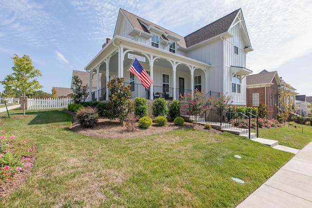 view of front of home with covered porch and a front yard