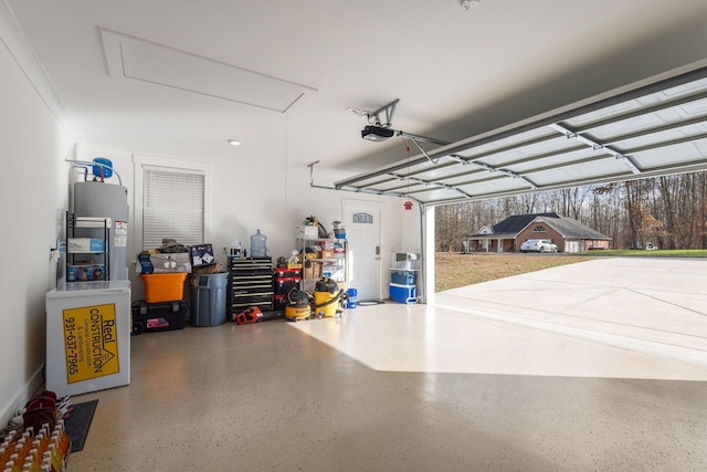 garage featuring a garage door opener and water heater