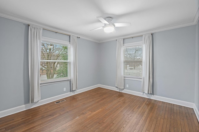 unfurnished room with hardwood / wood-style floors, ornamental molding, a healthy amount of sunlight, and ceiling fan