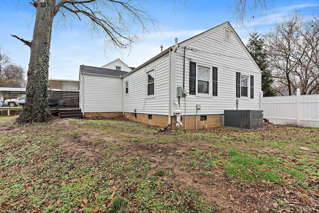 view of side of home with central AC