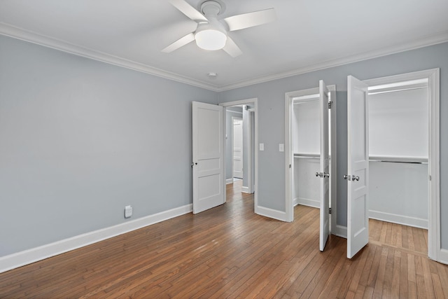 unfurnished bedroom featuring crown molding, hardwood / wood-style flooring, and ceiling fan