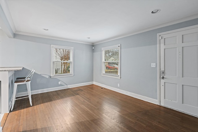 interior space with ornamental molding, plenty of natural light, and hardwood / wood-style floors