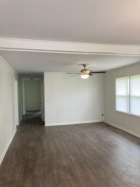 empty room featuring dark wood-type flooring and ceiling fan