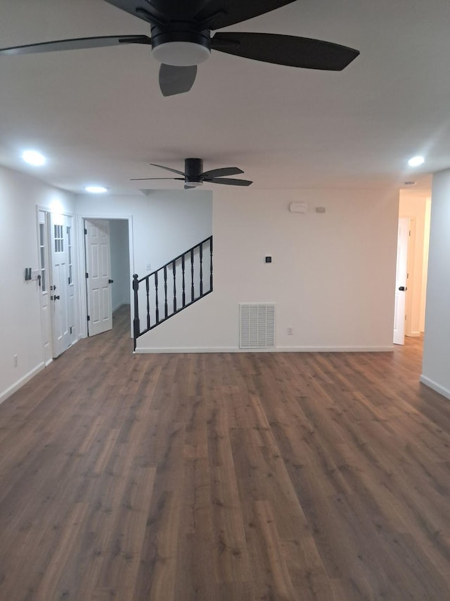 empty room with ceiling fan and dark hardwood / wood-style flooring