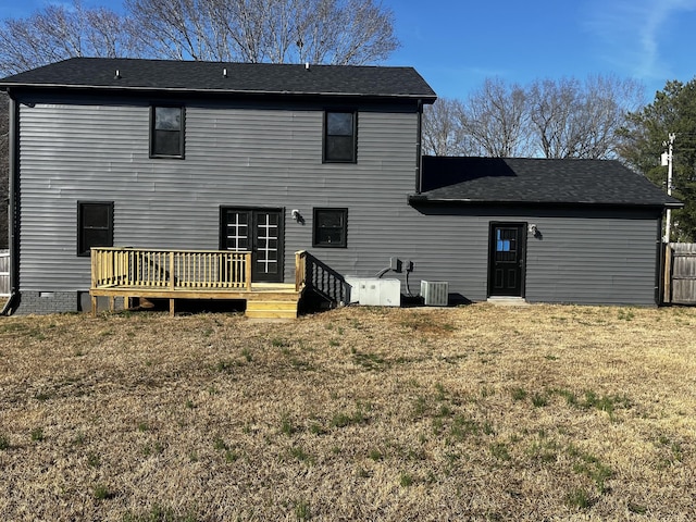 rear view of house with a yard, a deck, and central AC unit