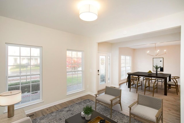 living room with an inviting chandelier and hardwood / wood-style floors