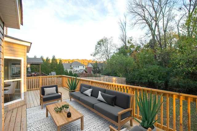 wooden terrace with an outdoor living space