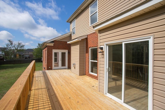 deck featuring a yard and french doors