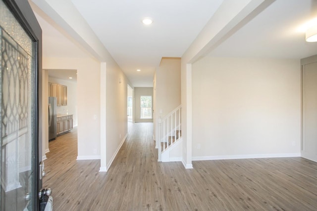 corridor with light hardwood / wood-style floors