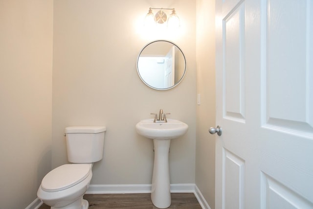 bathroom featuring hardwood / wood-style floors and toilet