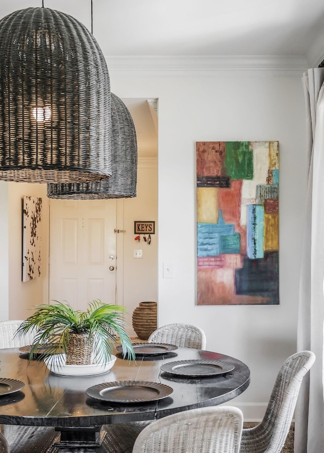 dining room featuring crown molding