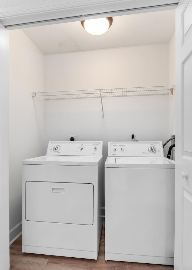 laundry room with light wood-type flooring and independent washer and dryer