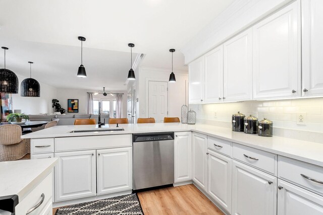 kitchen with white cabinetry, dishwasher, and kitchen peninsula