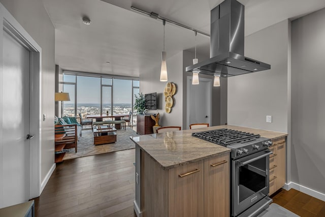 kitchen with dark wood-style floors, baseboards, stainless steel gas range, floor to ceiling windows, and island range hood