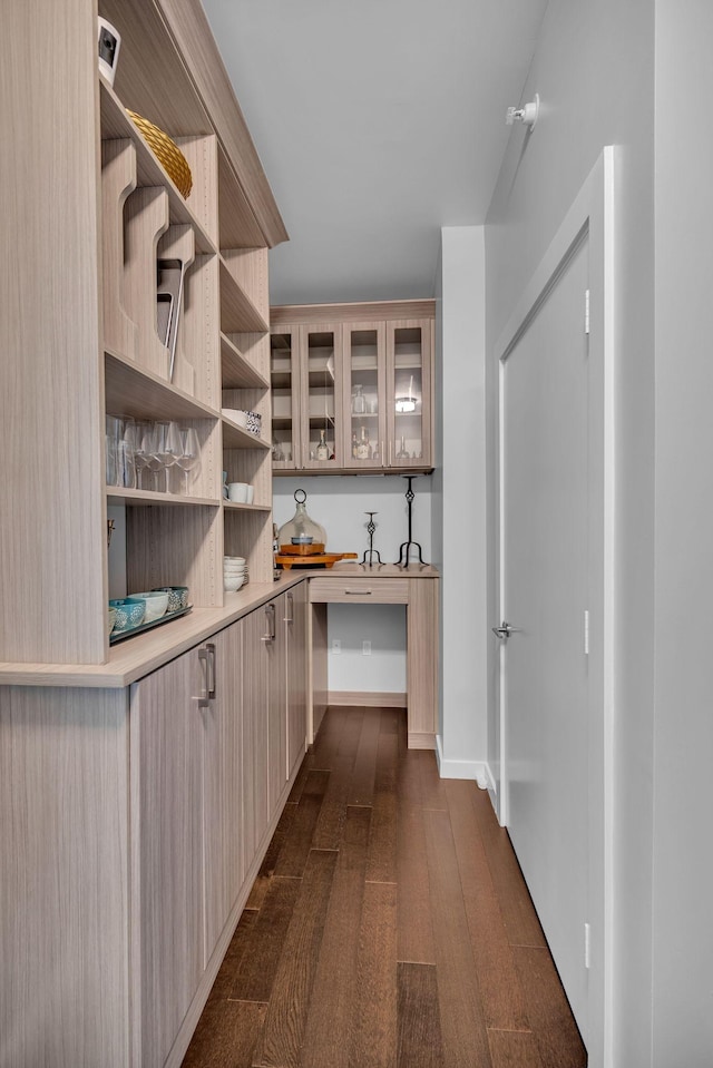 interior space with dark wood finished floors and baseboards