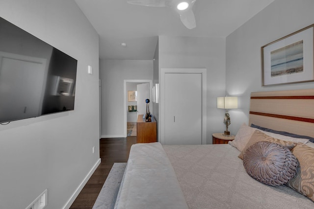 bedroom with a ceiling fan, baseboards, and wood finished floors