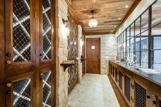 wine room with wooden ceiling and ornamental molding