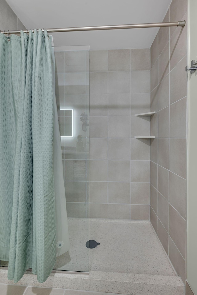 full bath featuring a tile shower