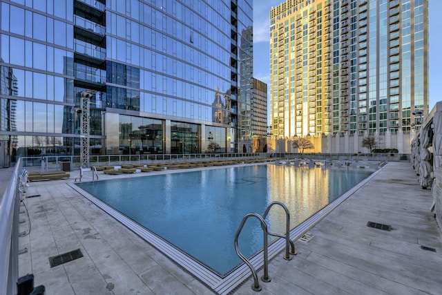 view of swimming pool with a city view