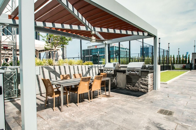 view of patio with grilling area, an outdoor kitchen, and outdoor dining area