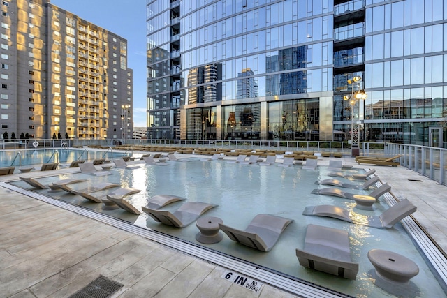 view of pool with a city view