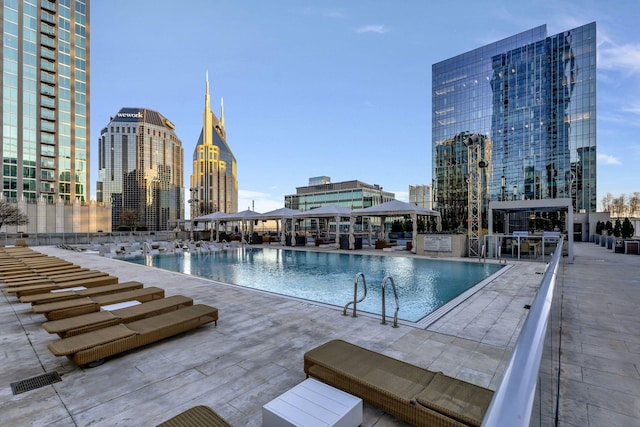 community pool featuring a patio area, a view of city, and a gazebo