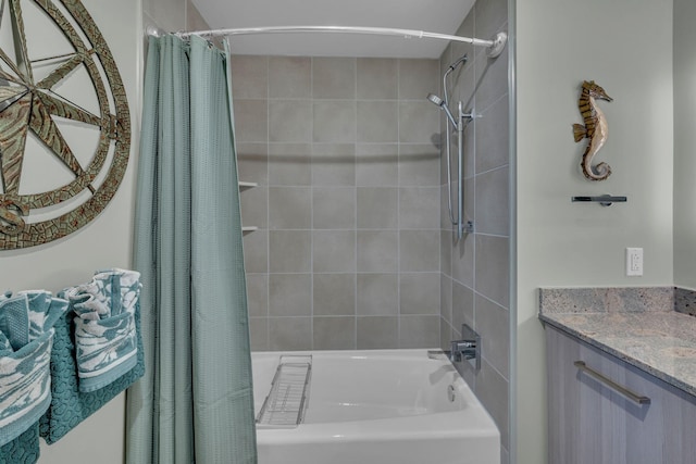 bathroom featuring shower / bath combo and vanity