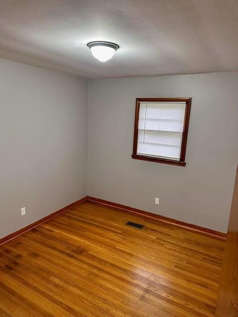 empty room with wood-type flooring