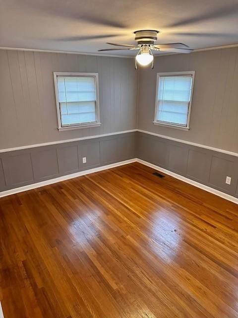 unfurnished room with hardwood / wood-style floors and ceiling fan